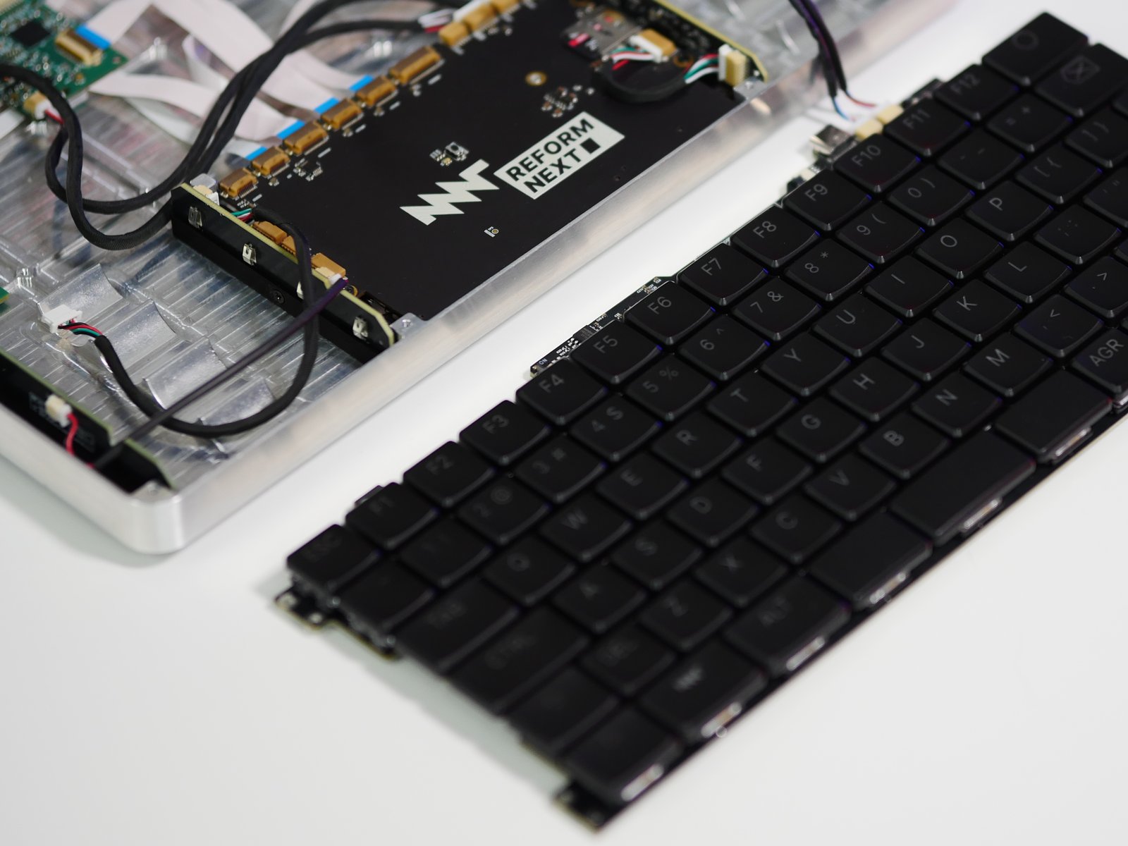 The MNT Reform keyboard, taken out of the Reform Next chassis and placed next to it on its own.