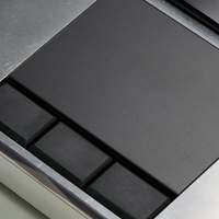 A close-up shot of the MNT Reform Next trackpad with three rectangular buttons below.