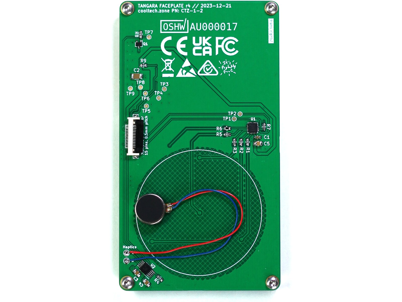 The reverse side of the same rectangular portrait-orientation PCB. There is a ZIF connector to connect to the main board, a small cylindrical haptic motor attached over the back of the touchwheel area, and some assorted components and test points.