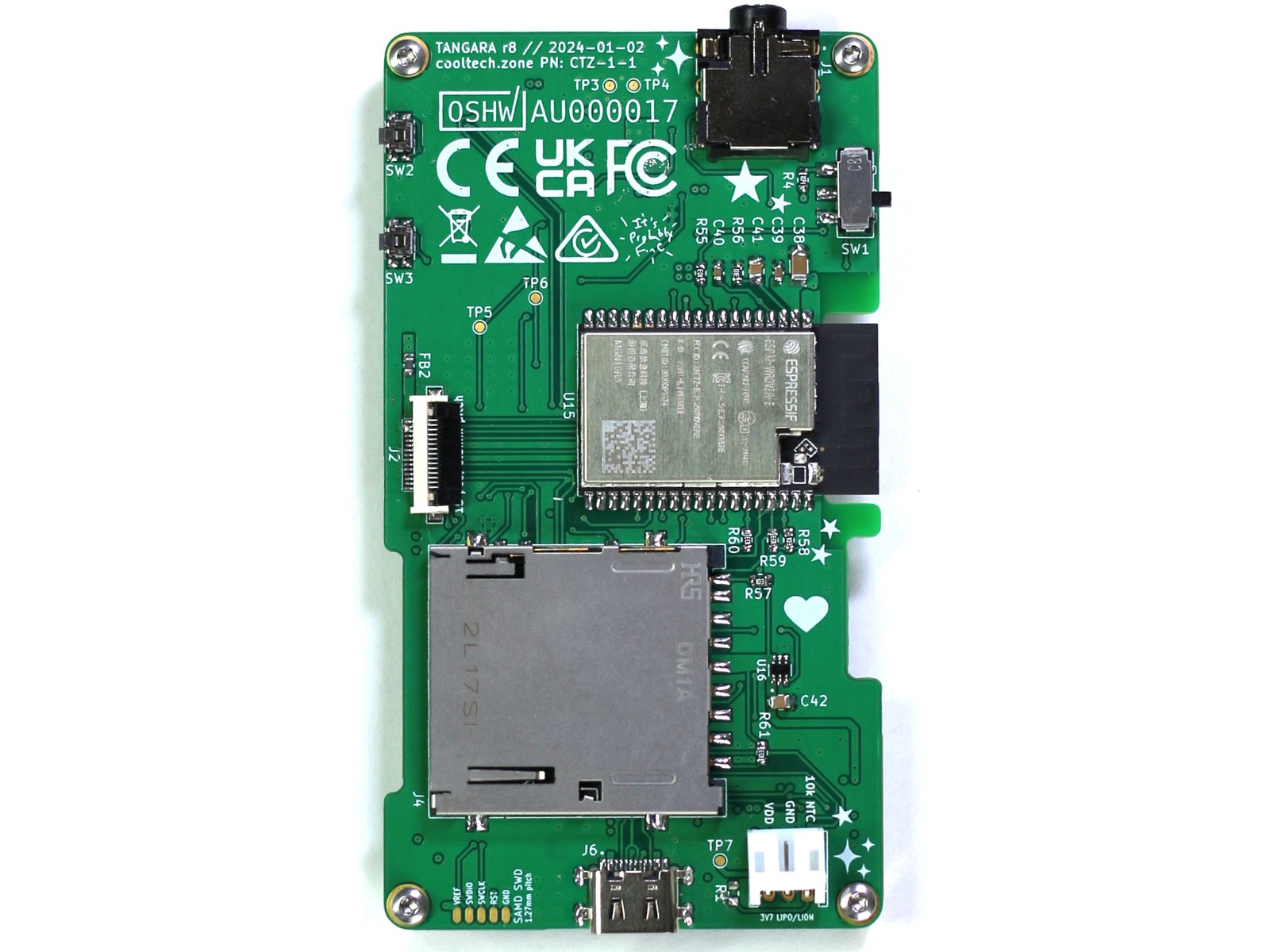 A rectangular, portrait-orientation PCB; it has a headphone jack, a switch, two small buttons, an ESP32 module, an SD card, a JST battery connector, and a USB-C port.